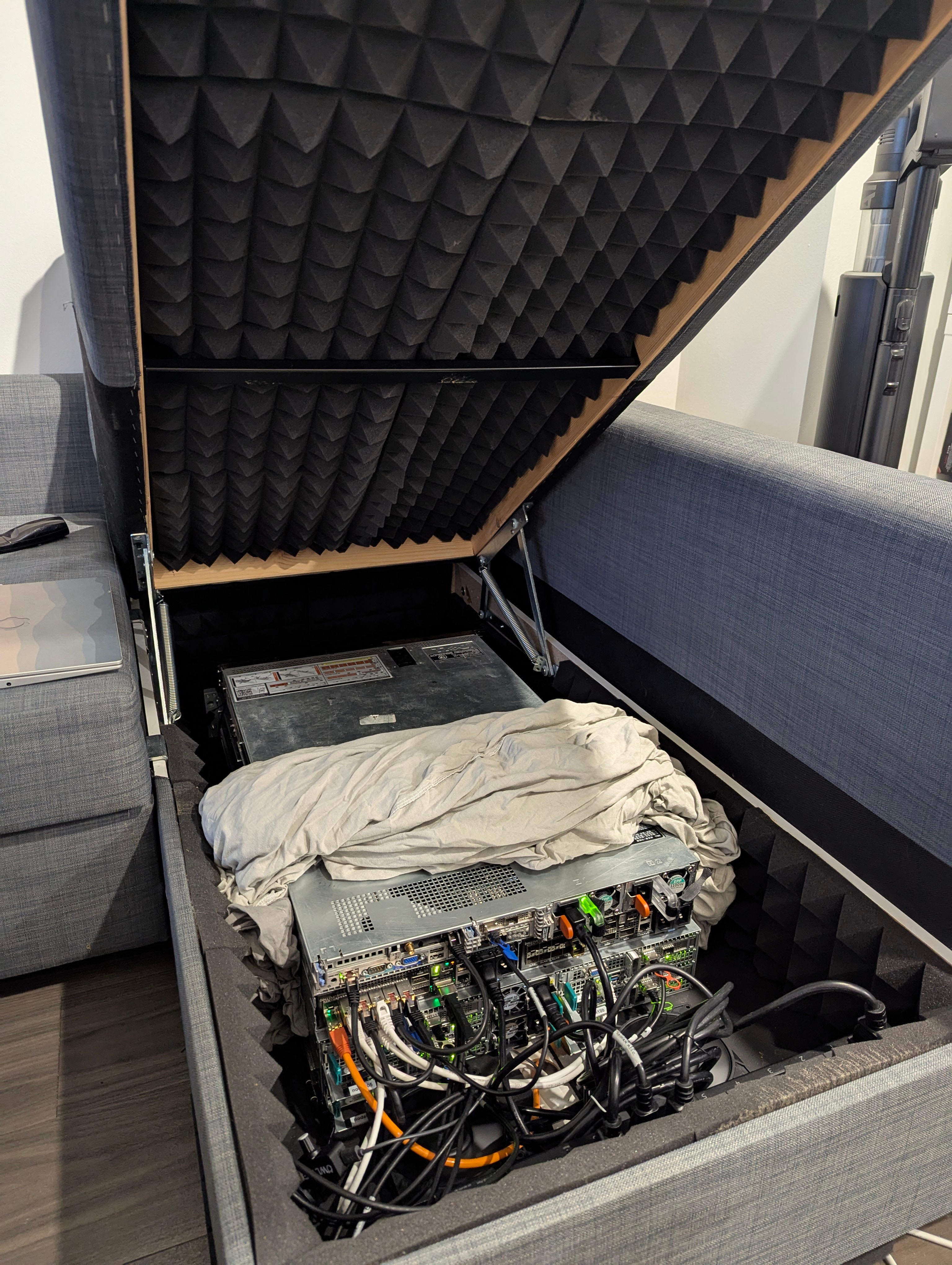 Image of servers inside of the storage compartment of a couch